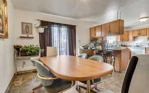 Dining space featuring stone finish flooring
