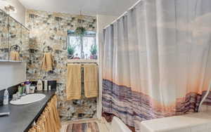 Full bath featuring a textured ceiling and vanity