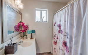 Bathroom featuring vanity and a shower with shower curtain