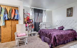 Bedroom featuring carpet floors and a closet