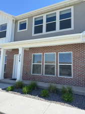 View of front of home featuring board and batten siding and brick siding