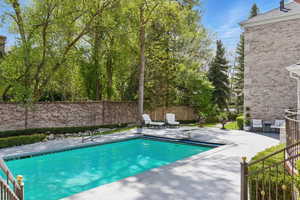 View of pool with a patio area, fence, and a fenced in pool