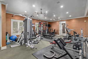 Workout area with crown molding, baseboards, and recessed lighting