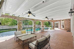 View of patio / terrace featuring ceiling fan, outdoor lounge area, and a fenced in pool