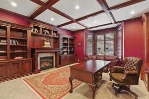 Office space featuring a premium fireplace, recessed lighting, coffered ceiling, beam ceiling, and light colored carpet
