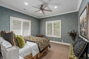 Carpeted bedroom with visible vents, recessed lighting, crown molding, a ceiling fan, and baseboards
