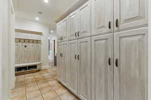 Mudroom with light tile patterned floors, crown molding, visible vents, baseboards, and recessed lighting