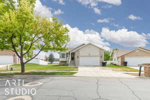 Single story home with concrete driveway, a garage, stucco siding, and a front lawn