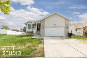 Ranch-style home with driveway, brick siding, fence, a garage, and a front yard