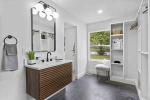 Full bathroom featuring baseboards and vanity