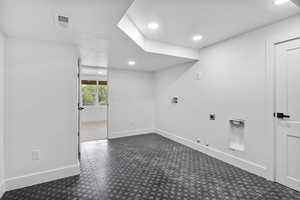 Empty room with a textured ceiling, visible vents, baseboards, and recessed lighting