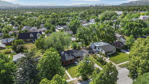 Aerial view of property's location with nearby suburban area and a mountainous background