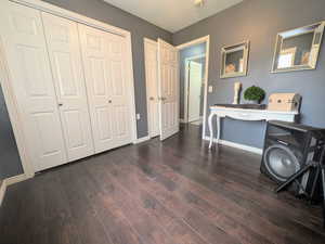 Entrance foyer featuring baseboards and dark wood-style flooring