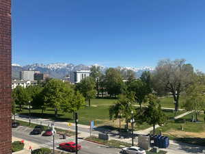Surrounding community with uncovered parking and a mountain view