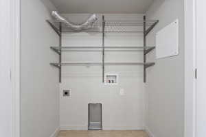 Laundry area with baseboards, hookup for an electric dryer, laundry area, and washer hookup