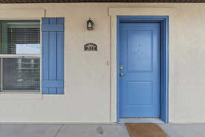 Entrance to property with stucco siding