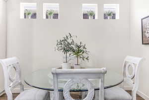 Dining space featuring baseboards and wood finished floors