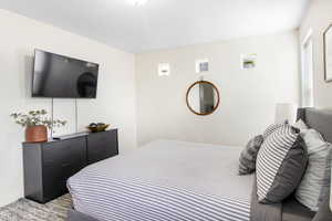 Bedroom featuring light colored carpet