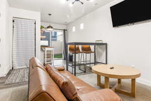 Living room featuring baseboards, visible vents, and wood finished floors