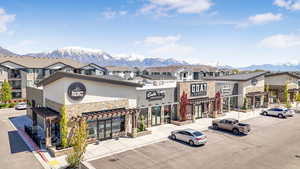 View of property with a mountain view and uncovered parking