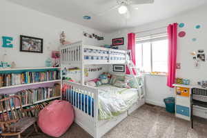 Carpeted bedroom featuring baseboards and a ceiling fan