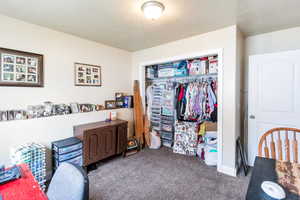 Interior space with a textured ceiling and a closet