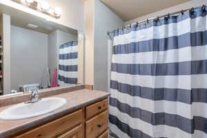 Bathroom featuring vanity and a shower with shower curtain