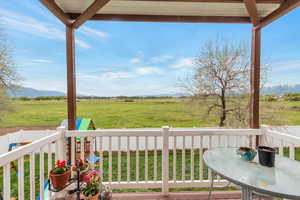 Deck with a rural view and a lawn