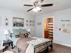 Bedroom featuring baseboards, carpet flooring, connected bathroom, and ceiling fan
