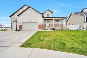 Beautiful Farm House style home with covered porch, 3 Car Garage and knock your socks of Curb Appeal!
