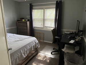 Carpeted bedroom featuring baseboards