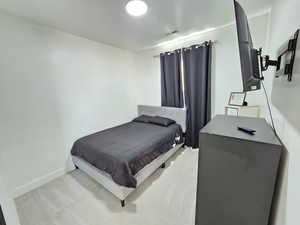 Bedroom featuring baseboards and visible vents