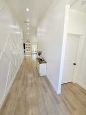 Hall with light wood-style floors, recessed lighting, baseboards, and visible vents