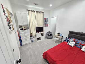Bedroom with carpet floors, baseboards, and visible vents