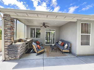 View of patio / terrace featuring an outdoor kitchen and ceiling fan