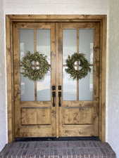 View of exterior entry featuring french doors