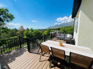 Deck with an outdoor living space and a mountain view