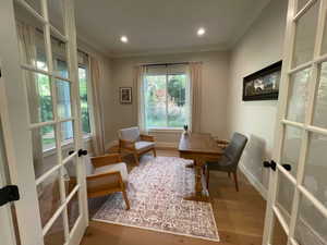 Living area featuring french doors, baseboards, wood finished floors, and recessed lighting