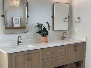 Bathroom featuring double vanity and a sink