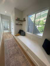 Corridor with light wood finished floors, recessed lighting, and baseboards