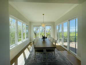 Sunroom / solarium featuring an inviting chandelier, french doors, baseboards, wood finished floors, and ornamental molding