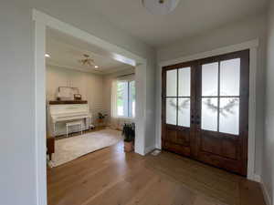 Entryway featuring french doors, wood finished floors, baseboards, and recessed lighting