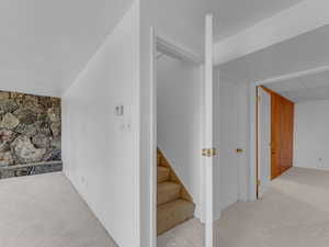 Corridor with stairs and carpet