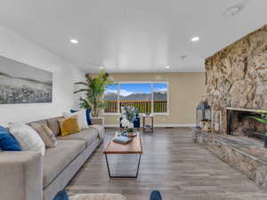 Living area with, a fireplace, recessed lighting, and wood finished floors