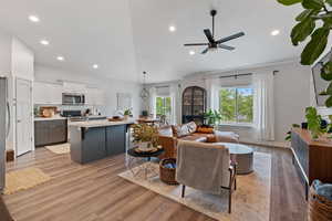 Living area with baseboards, recessed lighting, light wood-style floors, and ceiling fan