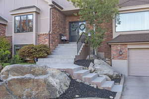 Property entrance featuring brick siding and french doors
