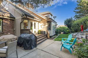 View of patio / terrace featuring a grill and a sunroom