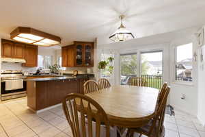Dining area with light tile patterned flooring and baseboards