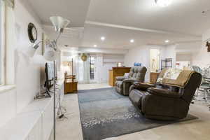 Carpeted living area featuring recessed lighting