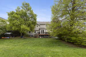 View of yard featuring stairs and a deck